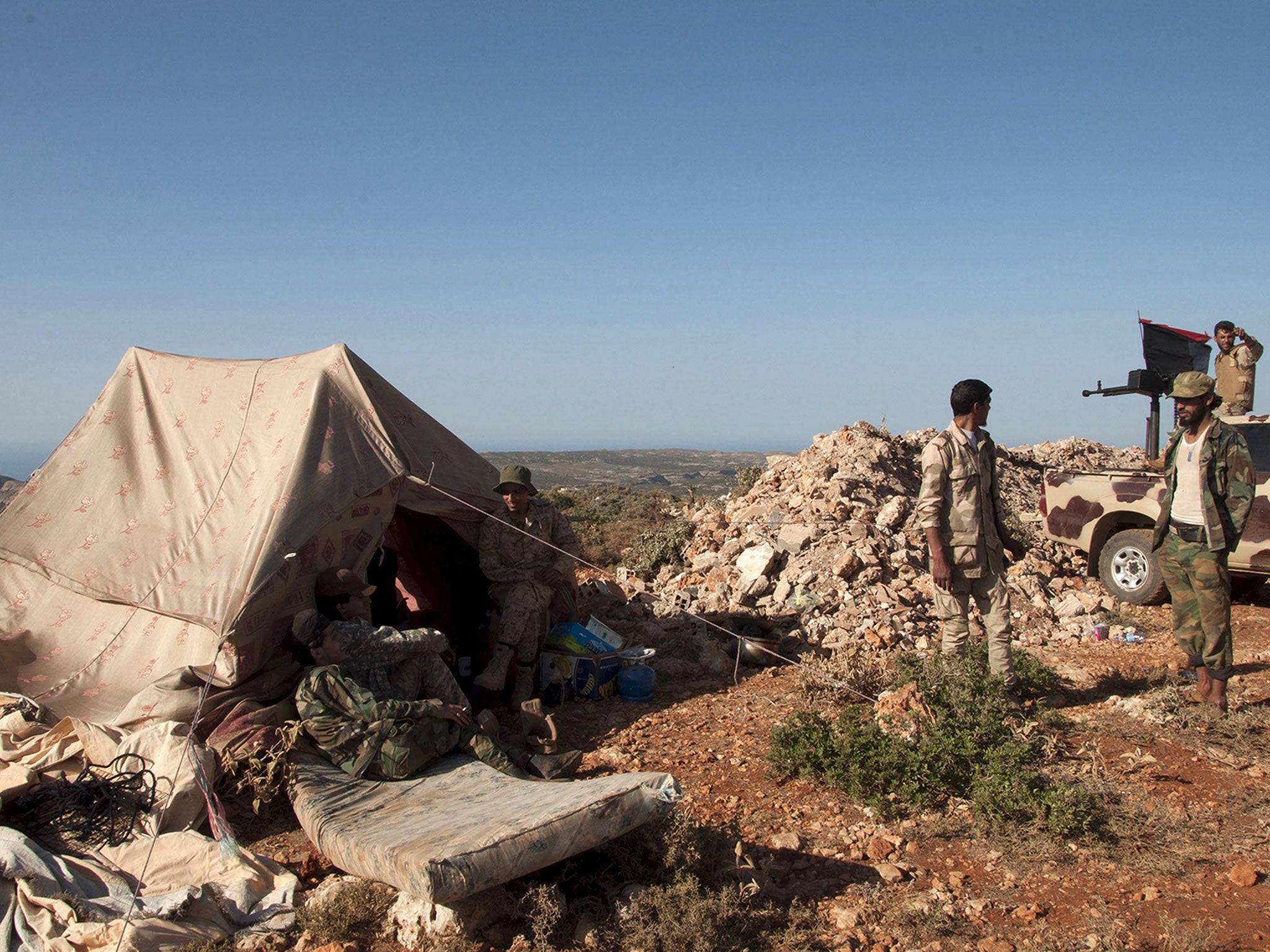 Members of the Libyan pro-government forces, stand near their tent during their deployment in the Lamluda area, southwest of the city of Derna, Libya June 16, 2015