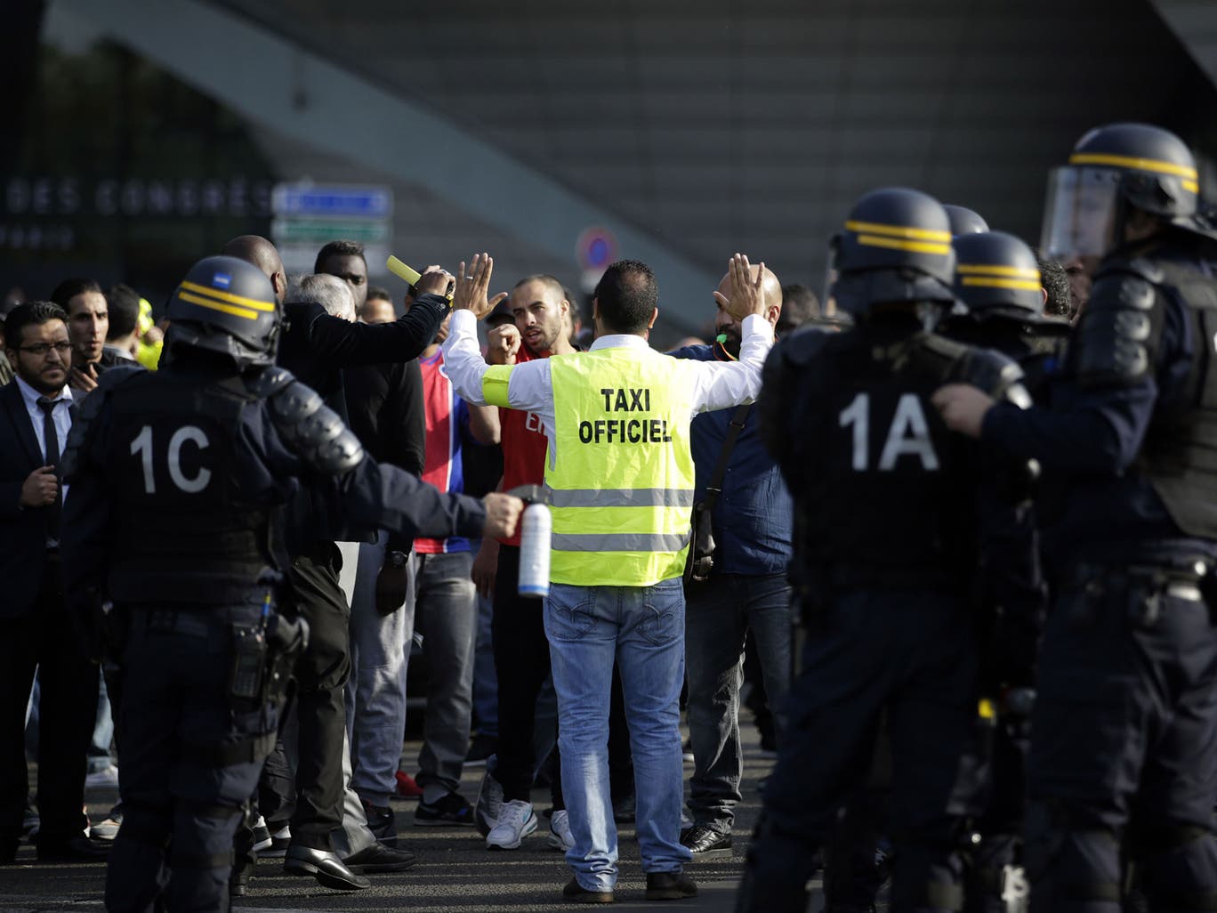 French CRS riot police arrive to intervene as demonstrators block Porte Maillot in Paris, as hundreds of taxi drivers converged on airports and other areas around the capital to demonstrate against UberPOP, a popular taxi app that is facing fierce opposition from traditional cabs. Access to three terminals at Paris-Charles de Gaulle airport and in a number of areas of Paris, especially Porte Maillot, were blocked 