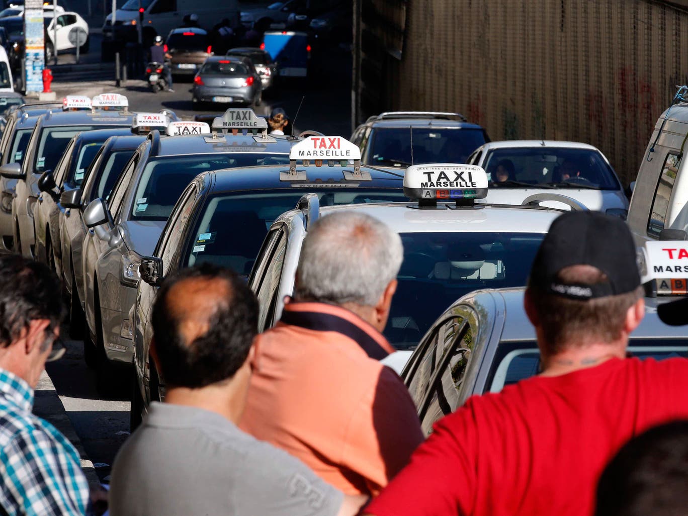 Taxi drivers on strike block the traffic during a national protest against car-sharing service Uber in Marseille 