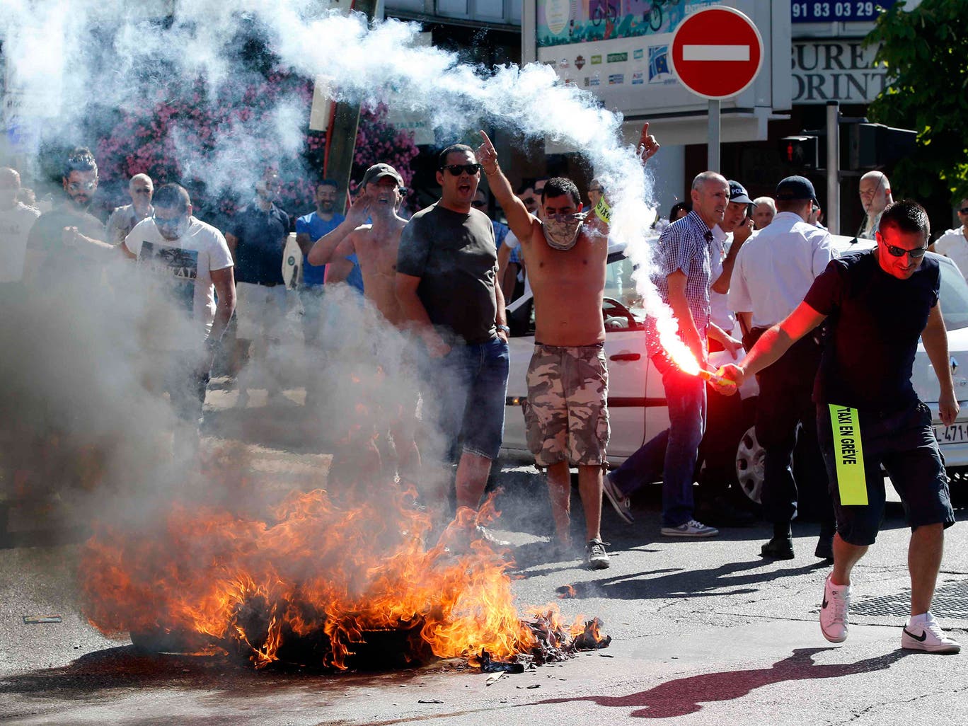 Taxi drivers on strike burn tyres during a national protest against car-sharing service Uber in Marseille, France. French taxi drivers stepped up protests against U.S. online cab service UberPOP, blocking road access to airports and train stations in Paris and other cities 