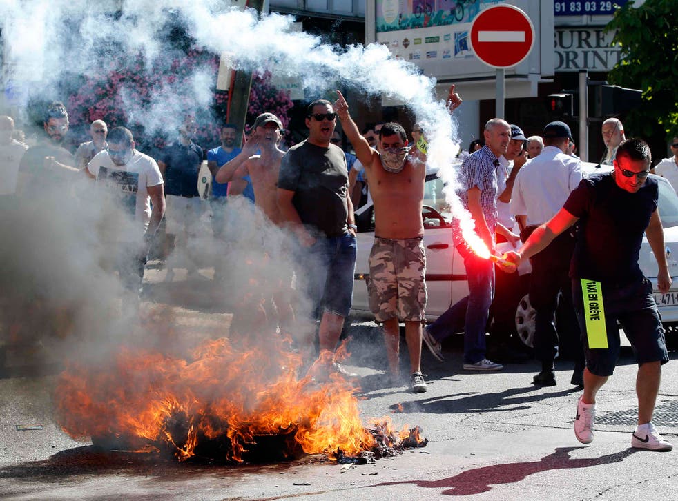 Taxi drivers on strike burn tyres during a national protest against car-sharing service Uber in Marseille, France. French taxi drivers stepped up protests against U.S. online cab service UberPOP, blocking road access to airports and train stations in Pari