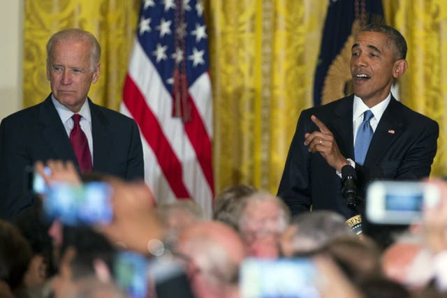 Good call: Joe Biden watches as Barack Obama coolly responds to a heckler at the White House