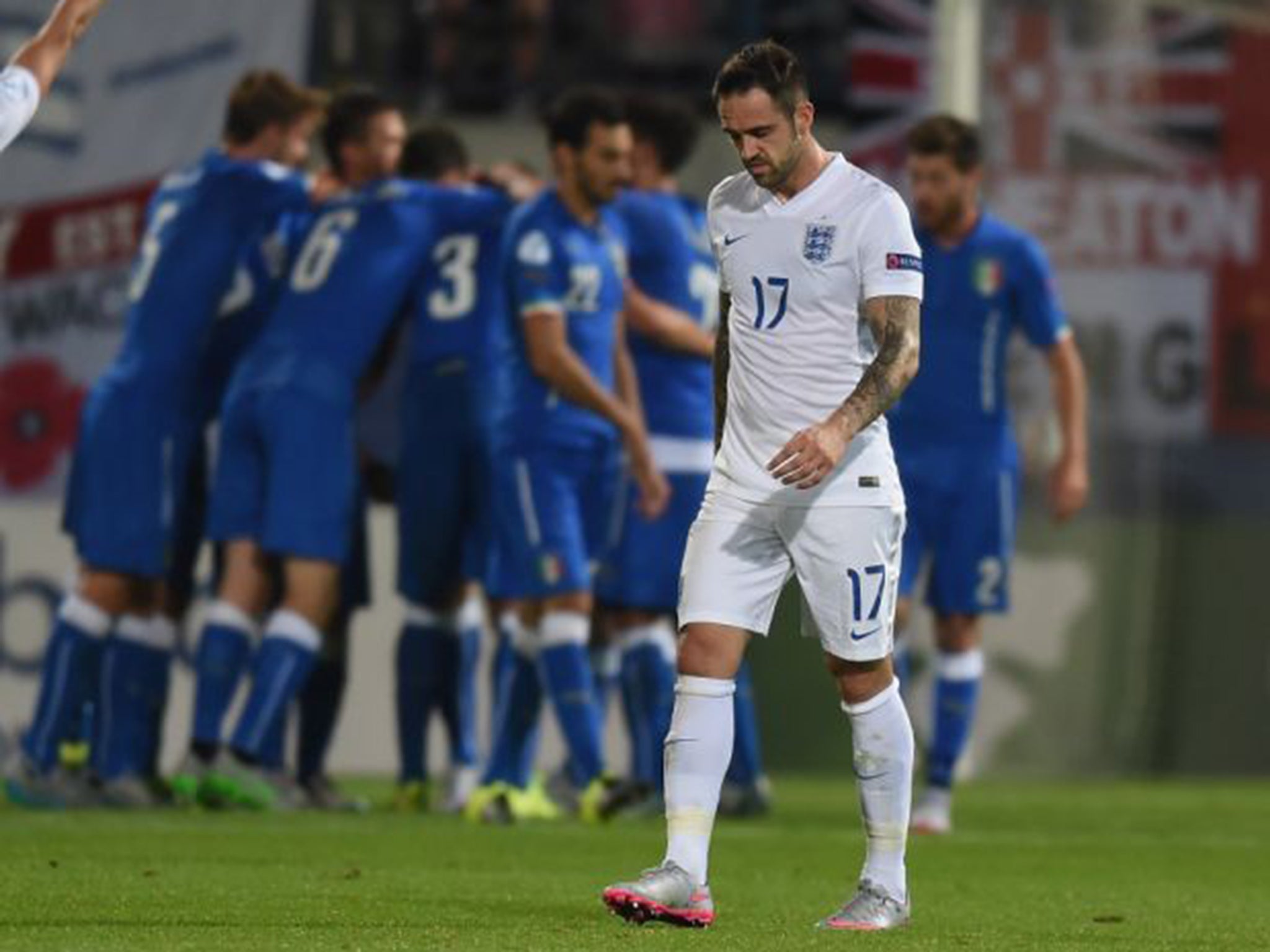 England’s Danny Ings looks downcast in Olomouc on Wednesday as the Italy players celebrate one of their goals