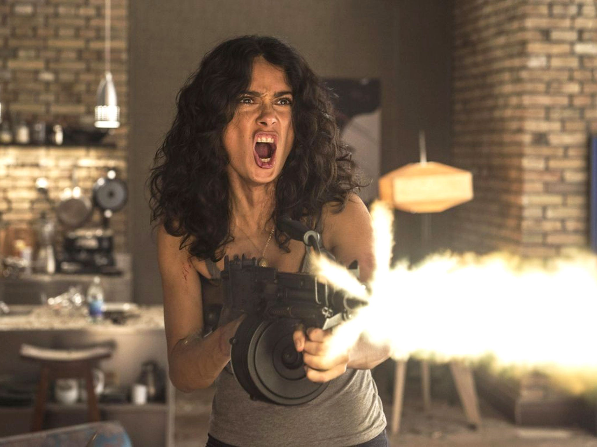 Salma Hayek appears to have picked up an ability to use guns and knives