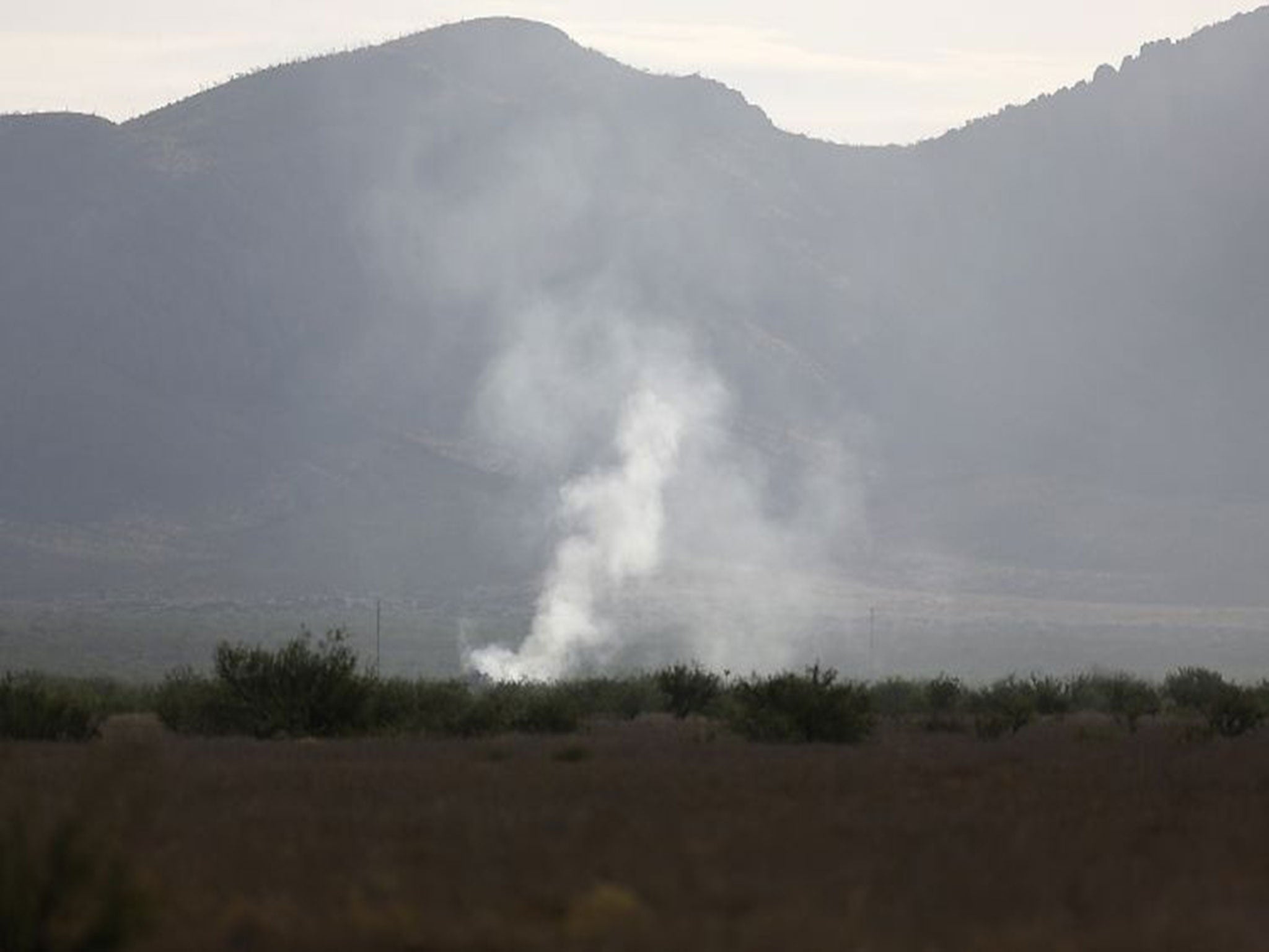 Smoke rises from the site where an F-16 Fighting Falcon crashed on Wednesday evening near Douglas, Arizona