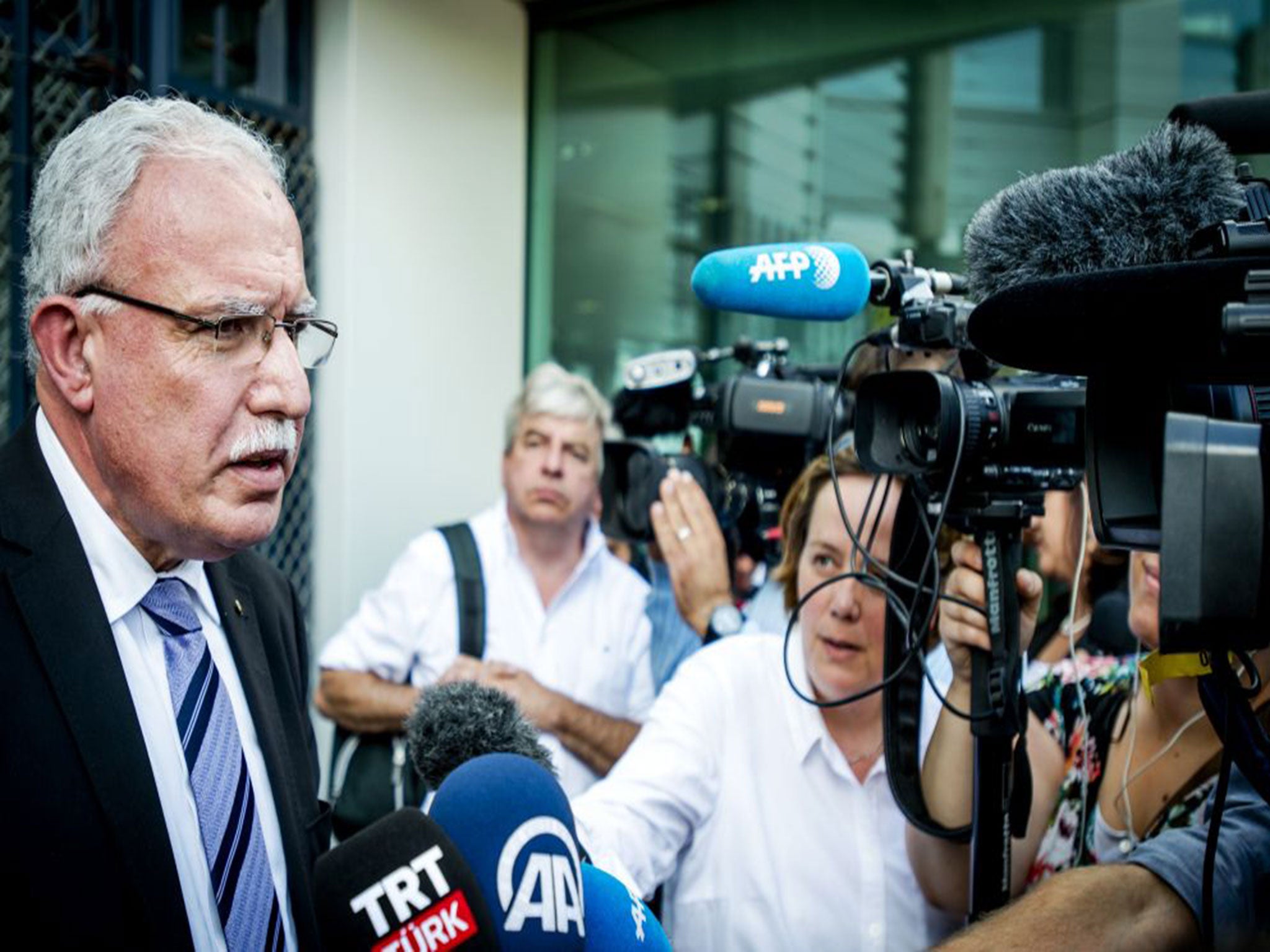 Palestinian foreign minister Riyad al-Maliki speaks to reporters in Hague after leaving the International Criminal Court (ICC).
