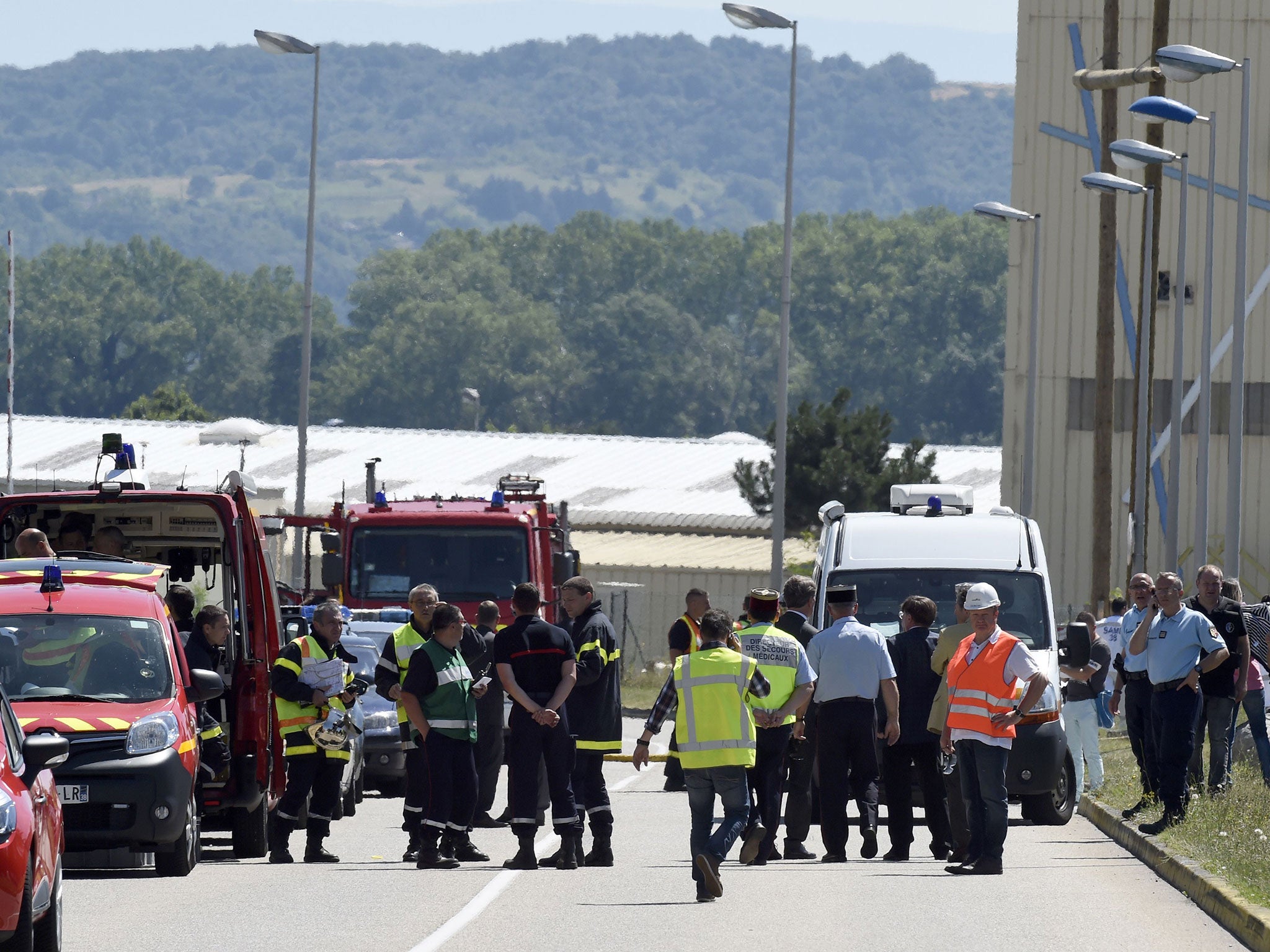 French police and firefighters secure the entrance of the Air Products company