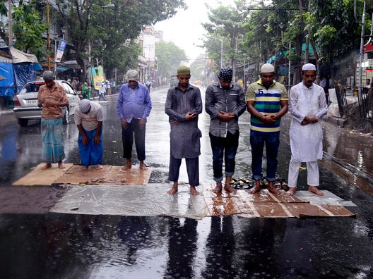 Muslim worshippers gather in prayer despite the flooding in Kolkata