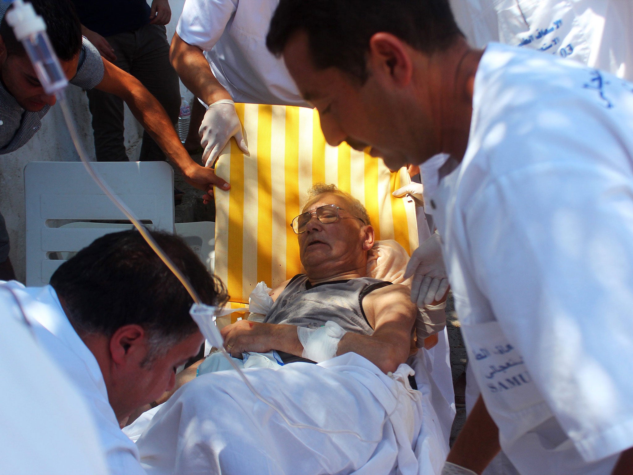 Medics help an injured man