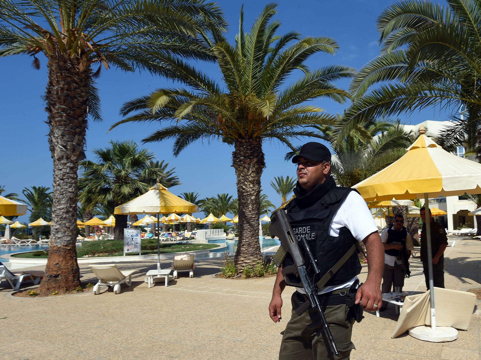 A Tunisian security member stands next to a swimming pool at the resort town of Sousse following a shooting attack