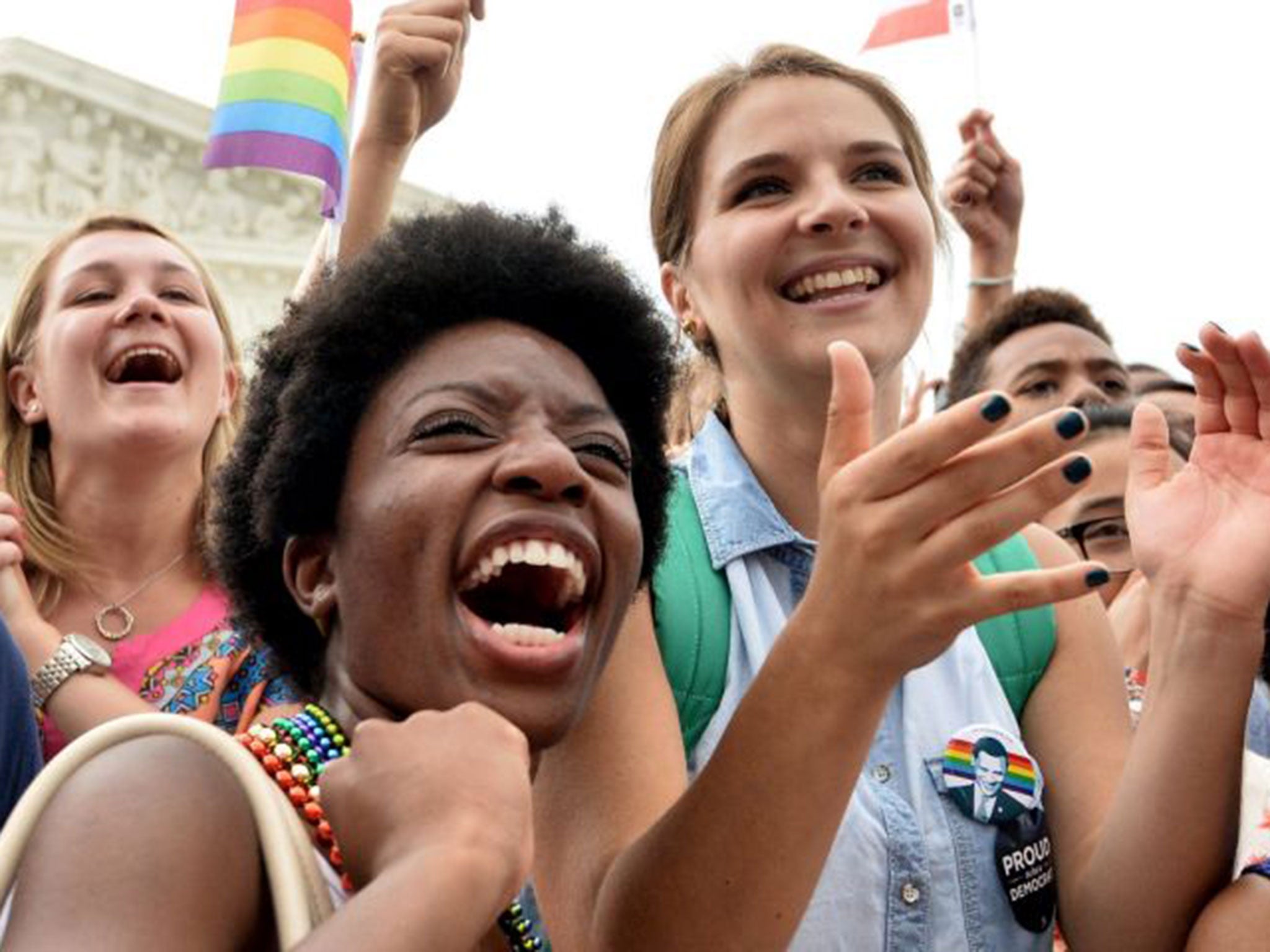 People celebrate outside the Supreme Court in Washington, DC on June 26, 2015 after its historic decision on gay marriage.