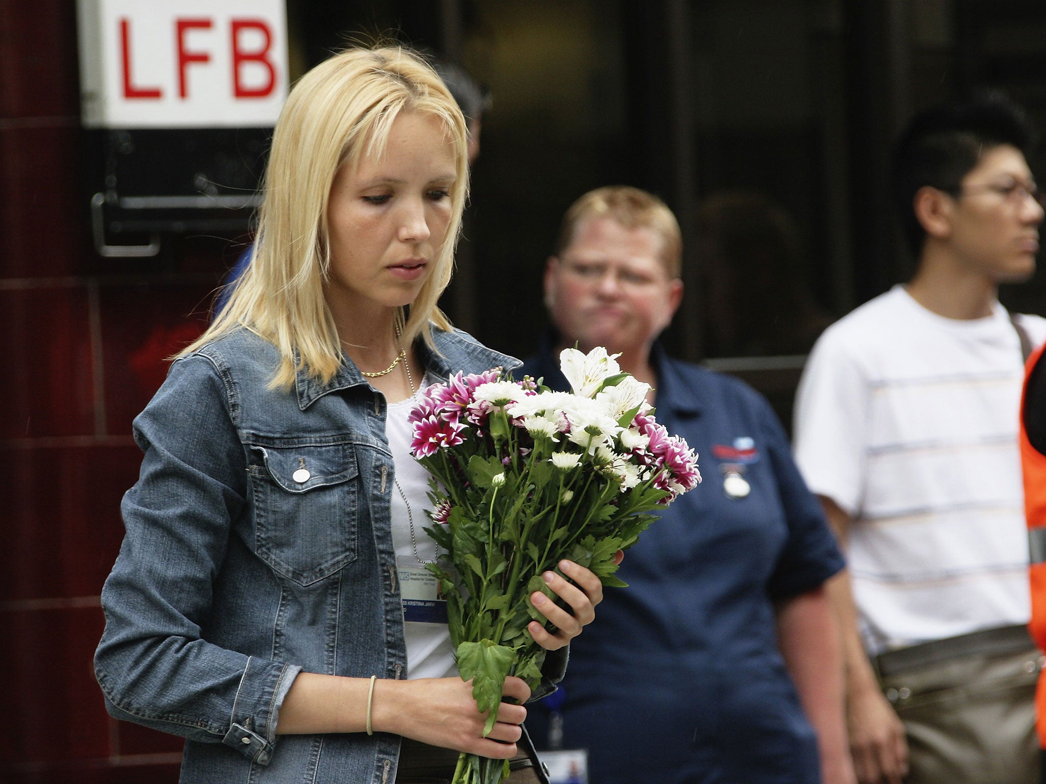 A mourner lays flowers to remember the victims of 7/7 bombings at Russell Square underground station on July 7, 2006 in London, England.