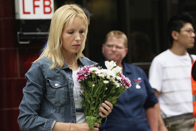 A mourner lays flowers to remember the victims of 7/7 bombings at Russell Square underground station on July 7, 2006 in London, England.