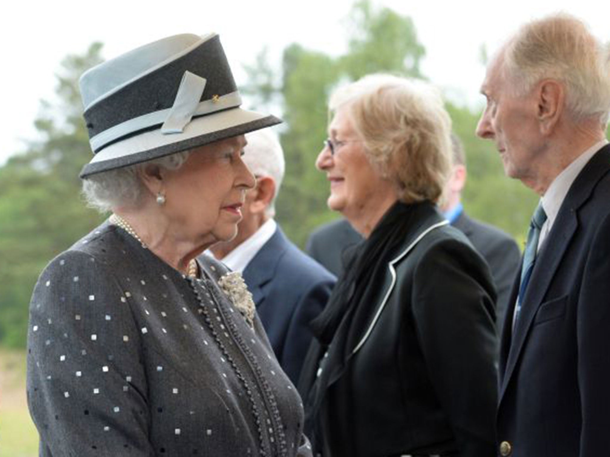 Captain Eric Brown (right) with the Queen at during a visit to the memorial site of Bergen-Belsen