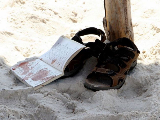 The bloodstained belongings of a tourist are seen on the sand in the resort town of Sousse