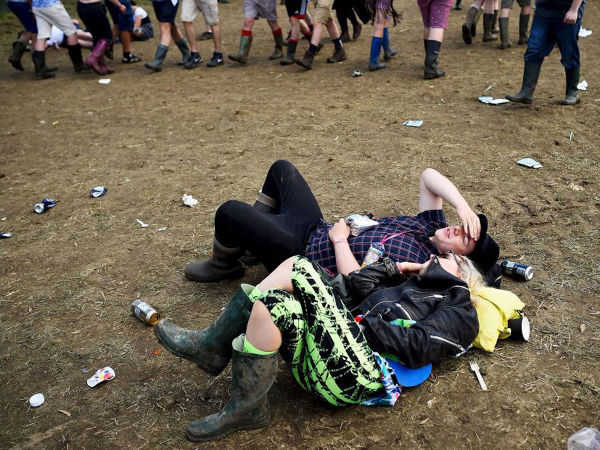 Revellers relax in front of the Other stage at Worthy Farm in Somerset during the Glastonbury Festival in Britain, June 27, 2015