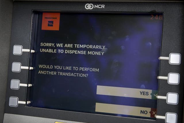 The message displayed on the monitor of a Piraeus Bank ATM in Athens. The Bank of Greece has recommended imposing restrictions on bank withdrawals 