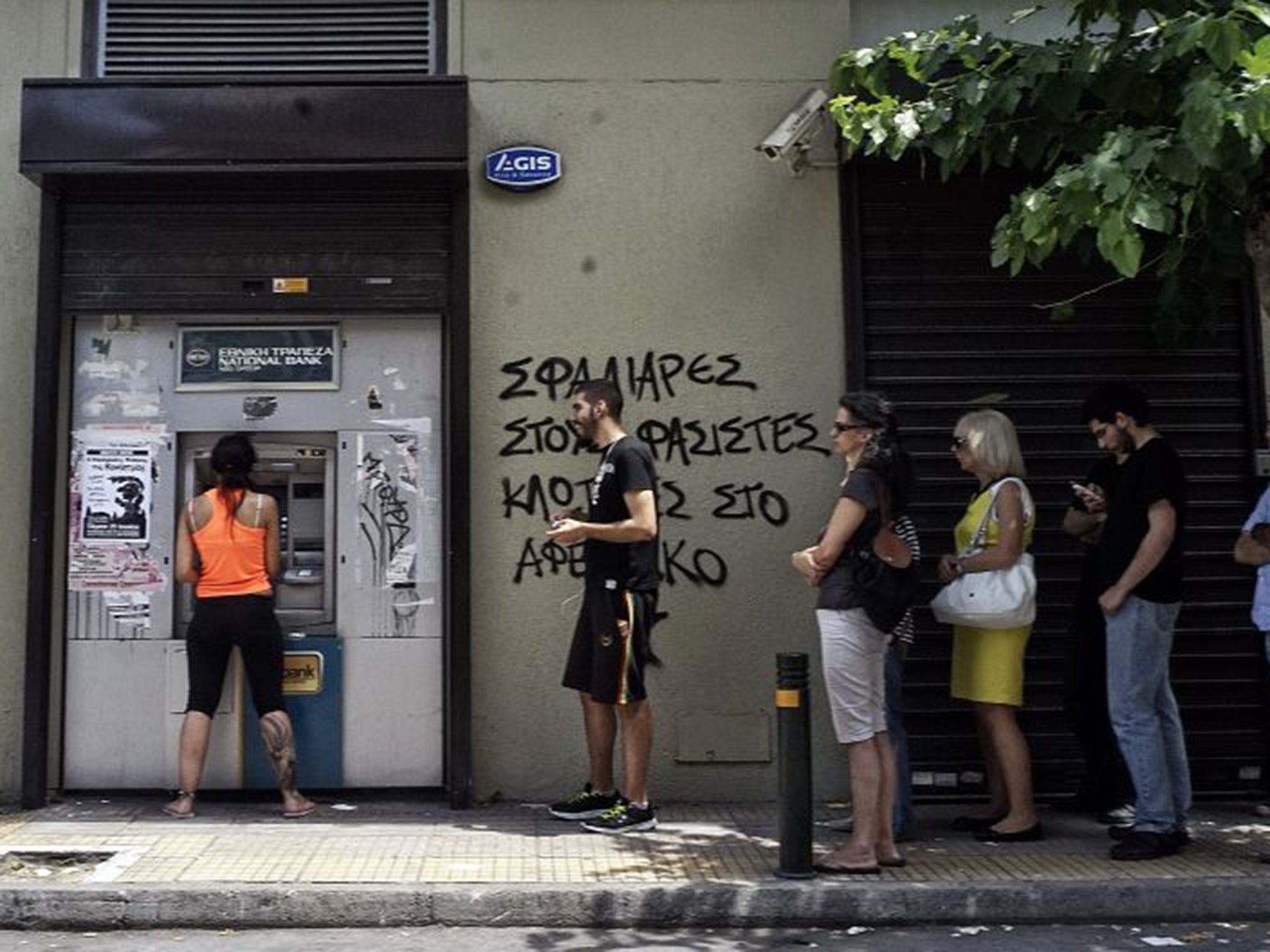 Greek people queue for cash in Athens