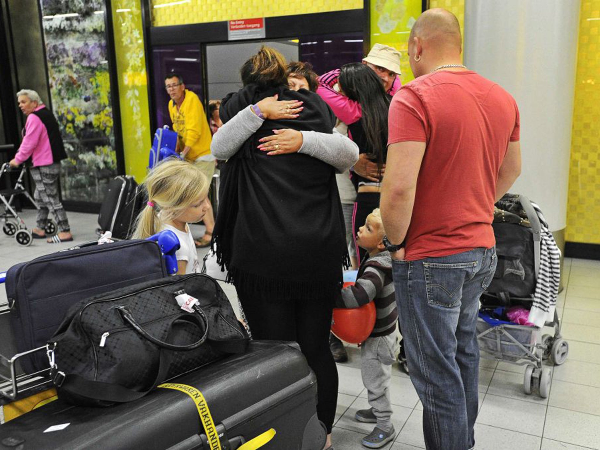 The travel group TUI put on extra flights to evacuate tourists, including this group arriving at Schiphol in Amsterdam