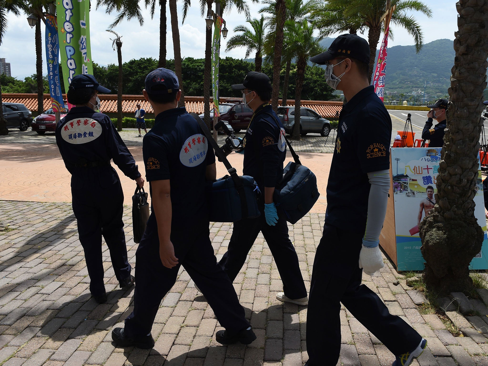 Local investigators arrive at the water park in Pali district, in New Taipei City