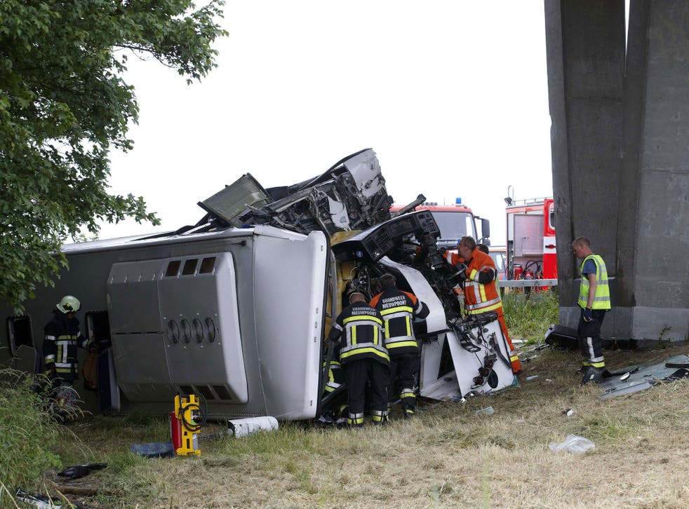 Rescue services work at the site where a bus carrying 34 British schoolchildren crashed off the E40 highway in Middelkerke, Belgium