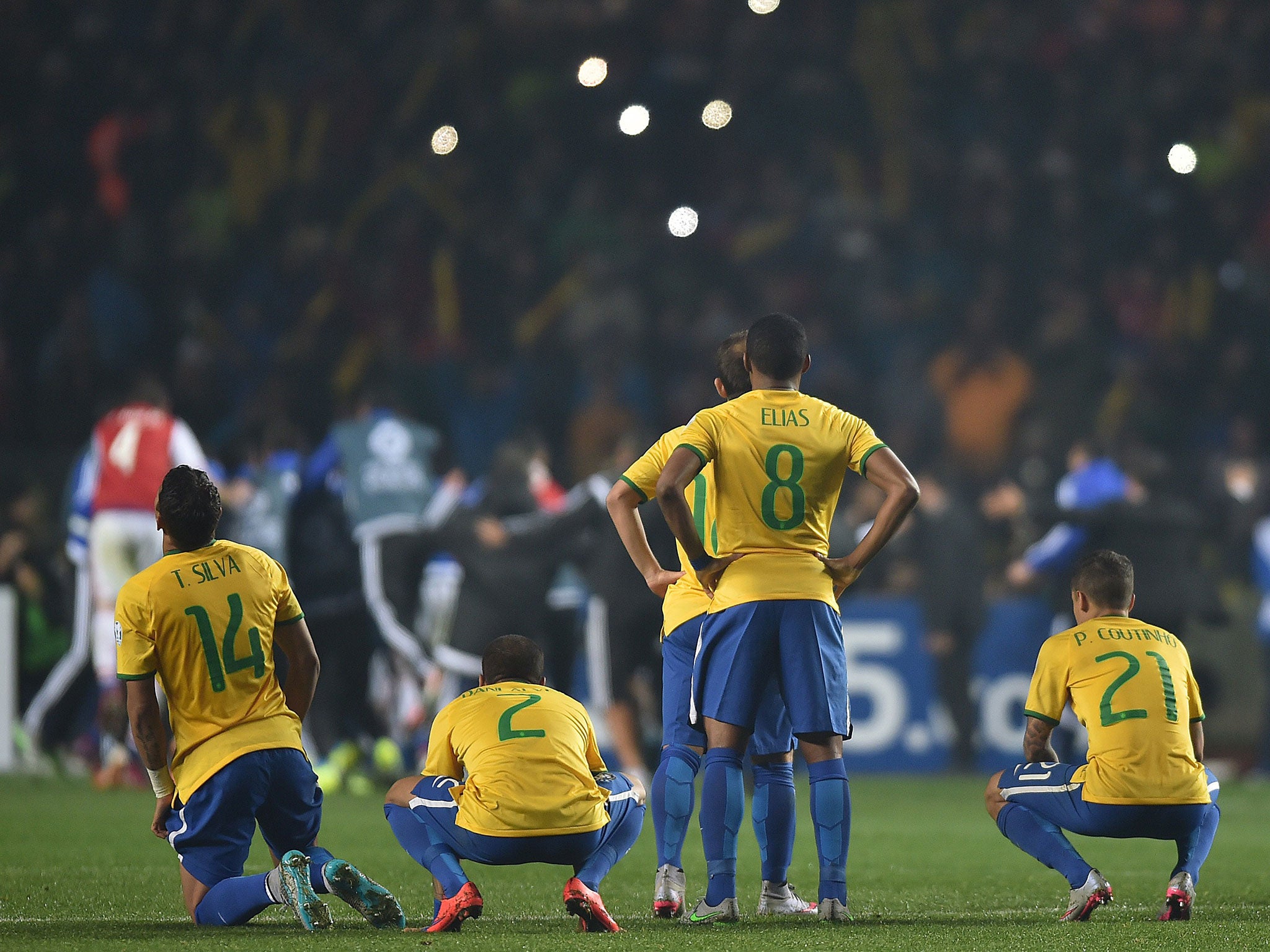 Brazil players react after losing to Paraguay on penalties