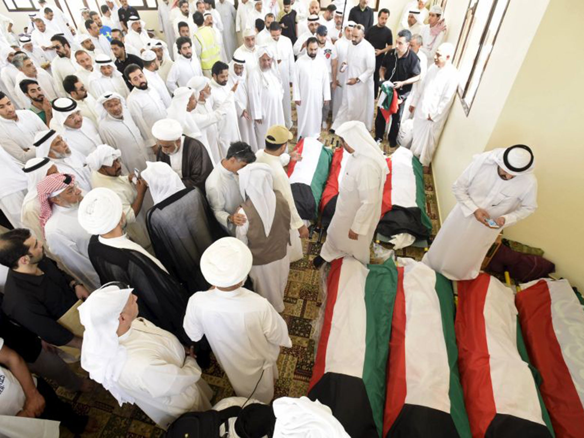 Coffins of some of the 27 people killed by a suicide bomb at a mosque in Kuwait City on Friday