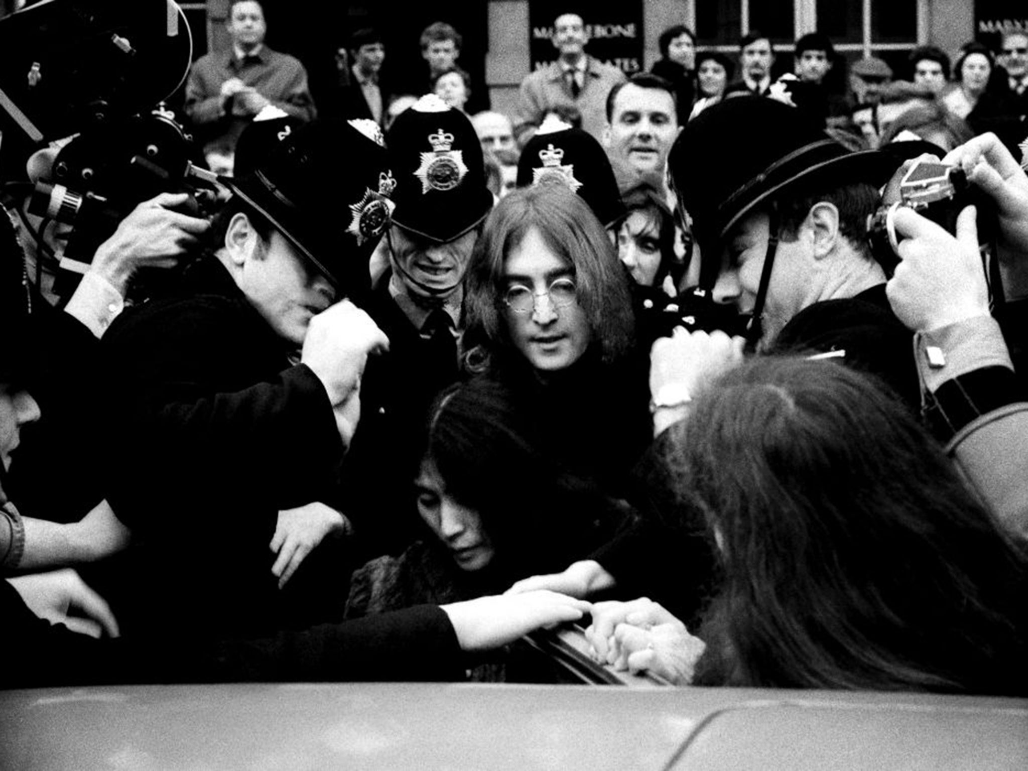 John Lennon and Yoko Ono leave Marylebone Magistrates' Court in London in 1968. The couple were appearing on charges of drug possession