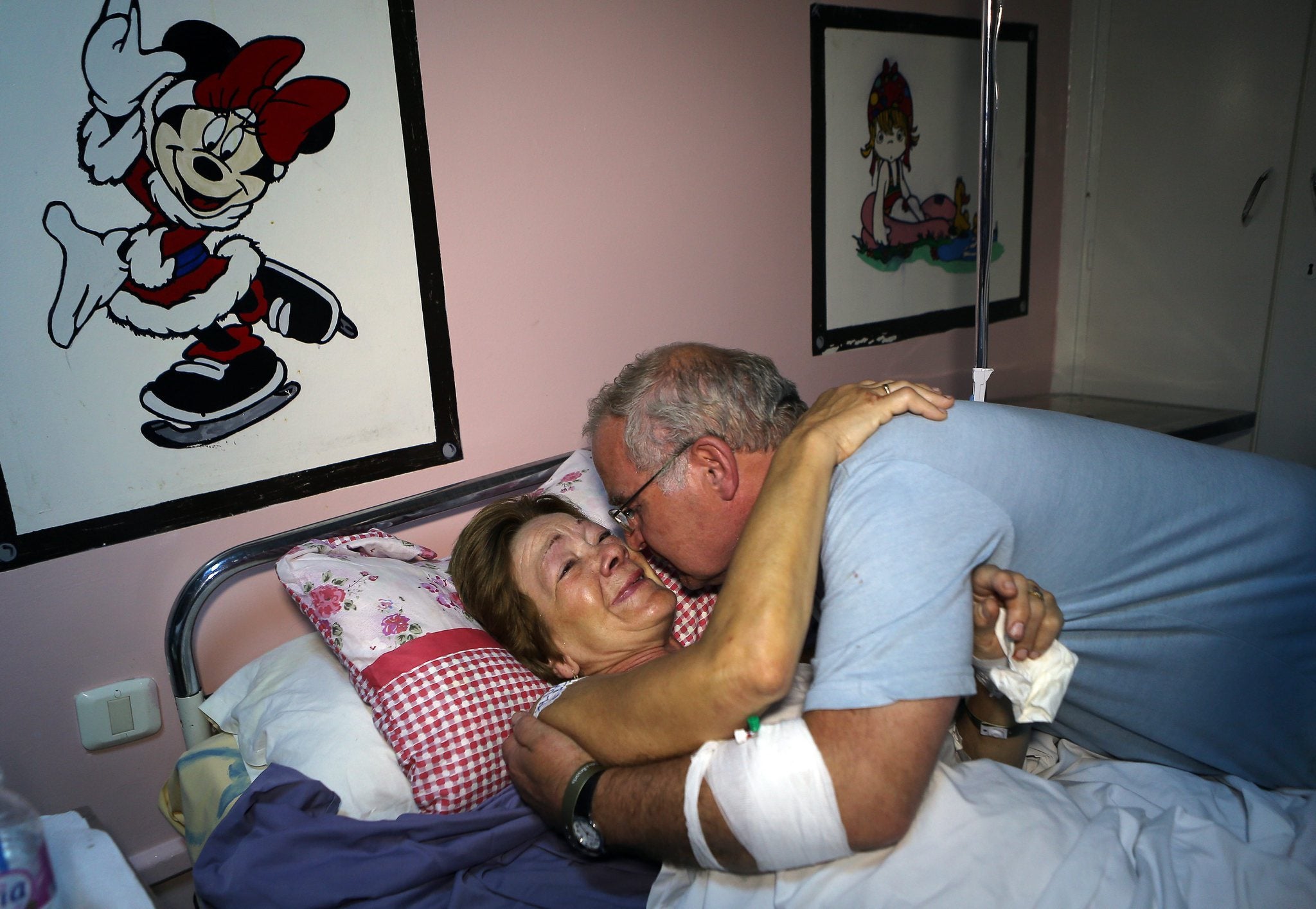 Tony Callaghan visits his wife, Christine, in hospital after the attack (via EPA)