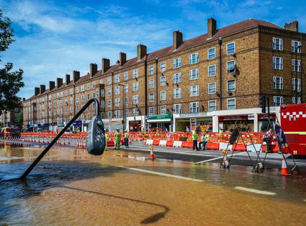 Street light collapsed in Kennington flood: Firefighters work to clear the area of water
