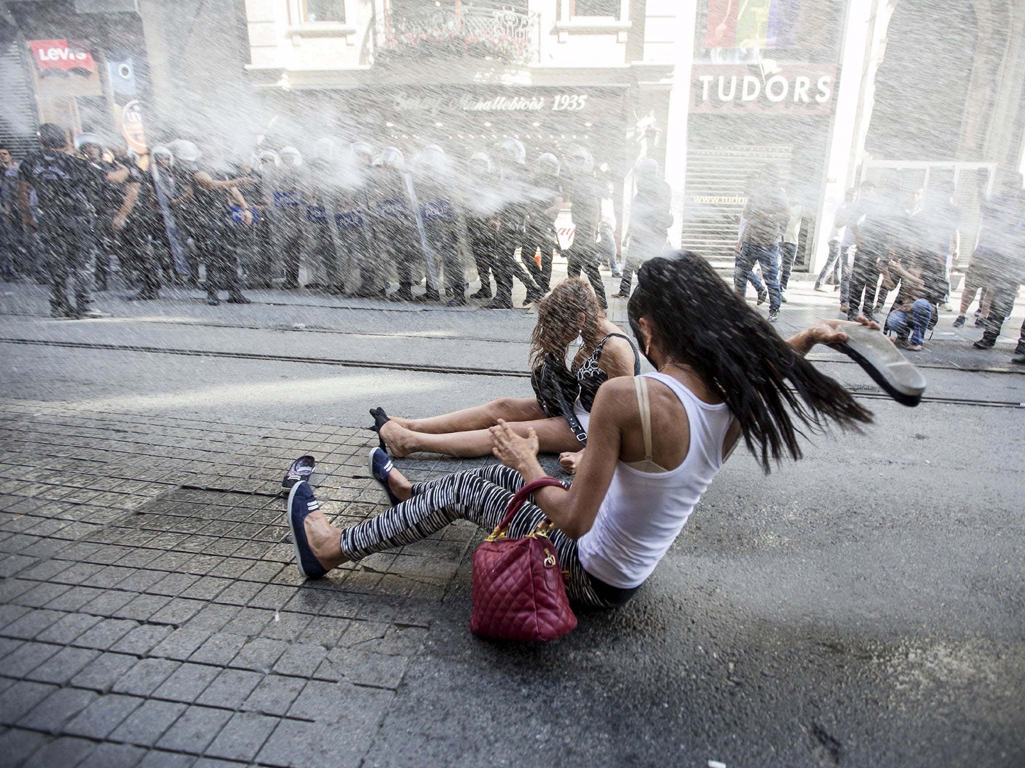 Riot police use a water cannon to disperse LGBT rights activist before a Gay Pride Parade in central Istanbul, Turkey