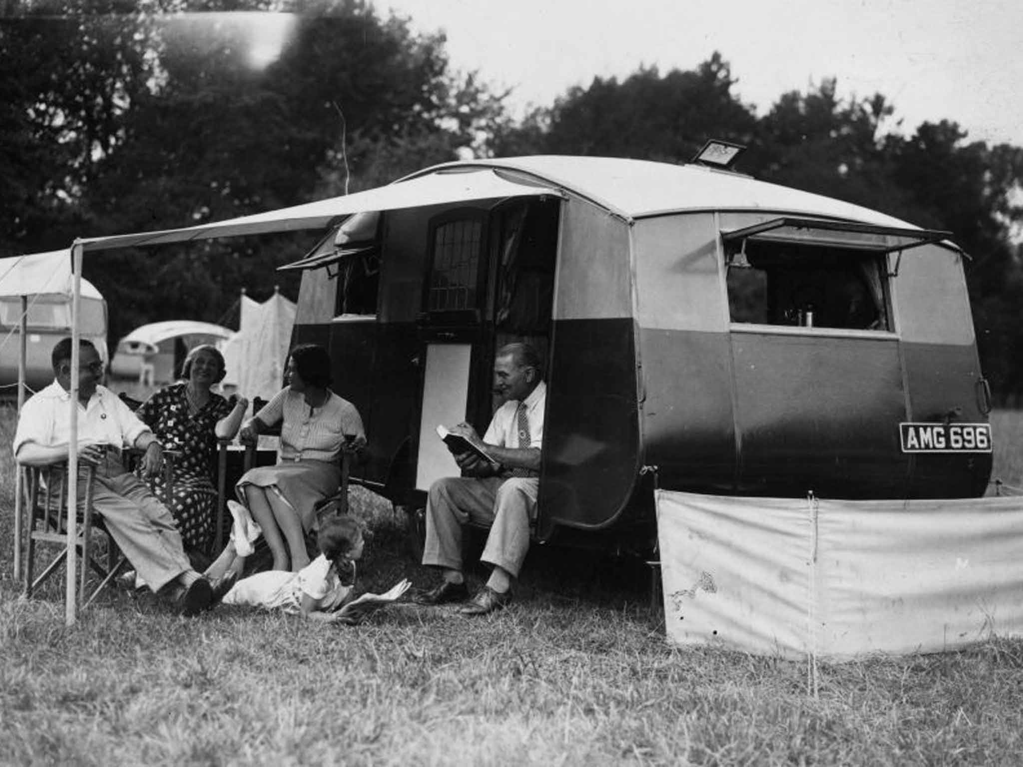 Happy campers: a family relax outside their caravan in Berkshire in 1934