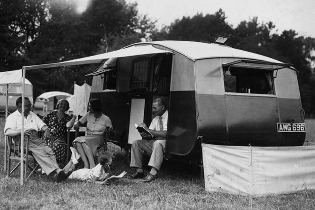 Happy campers: a family relax outside their caravan in Berkshire in 1934