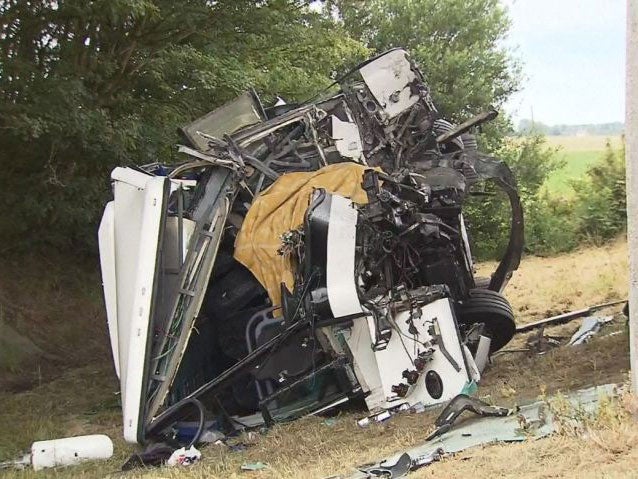 The wreckage of the crashed school coach, which was carrying 34 schoolchildren when it collided with a motorway bridge pillar