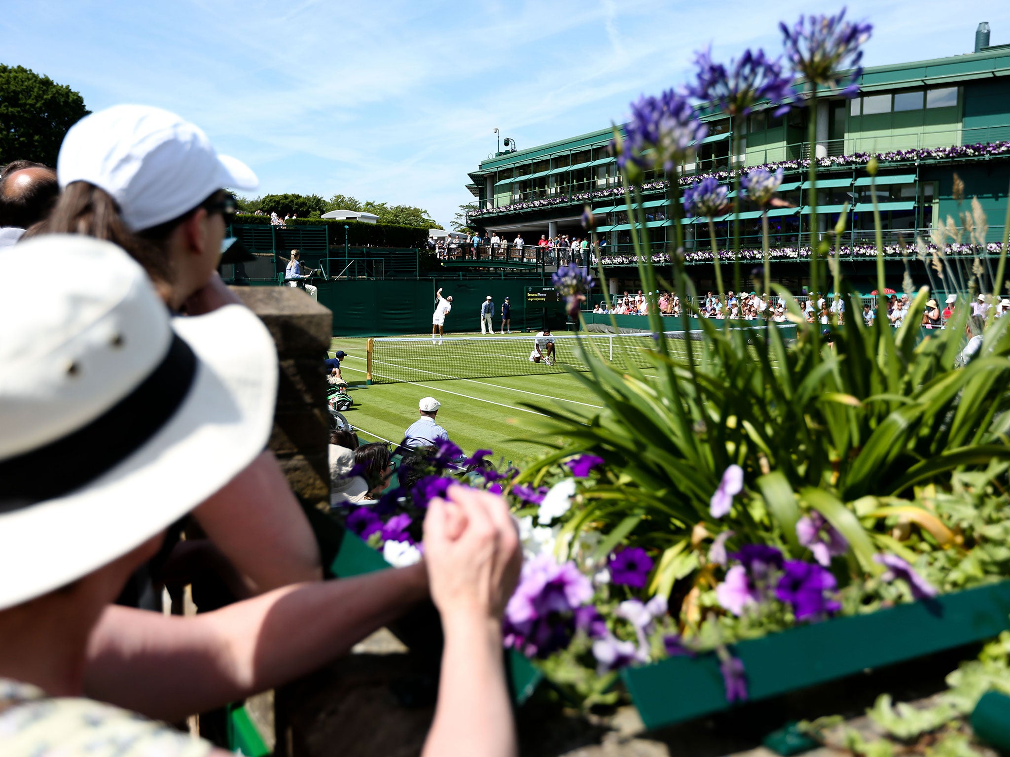 A general view of Court 19 as Florin Mergea serves on day 1 of the Wimbledon championships
