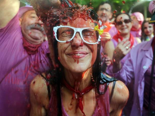 A woman gets a bucket of wine poured over her head at this year's Batalla de Vino
