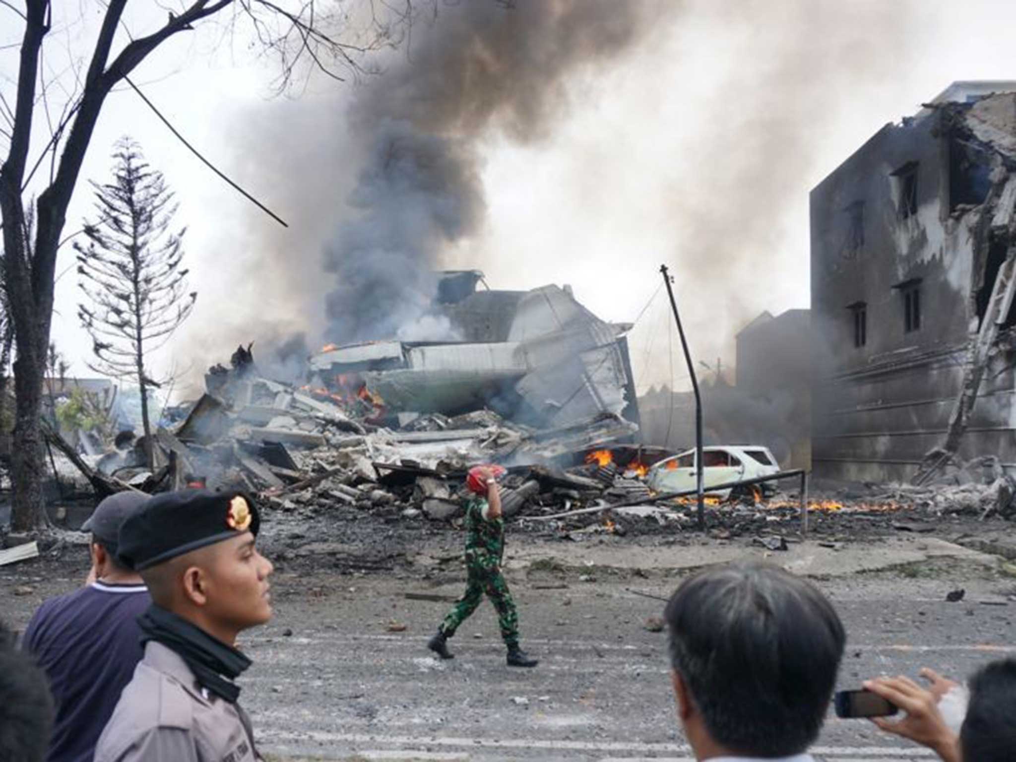 An Indonesian soldier secures the crash site