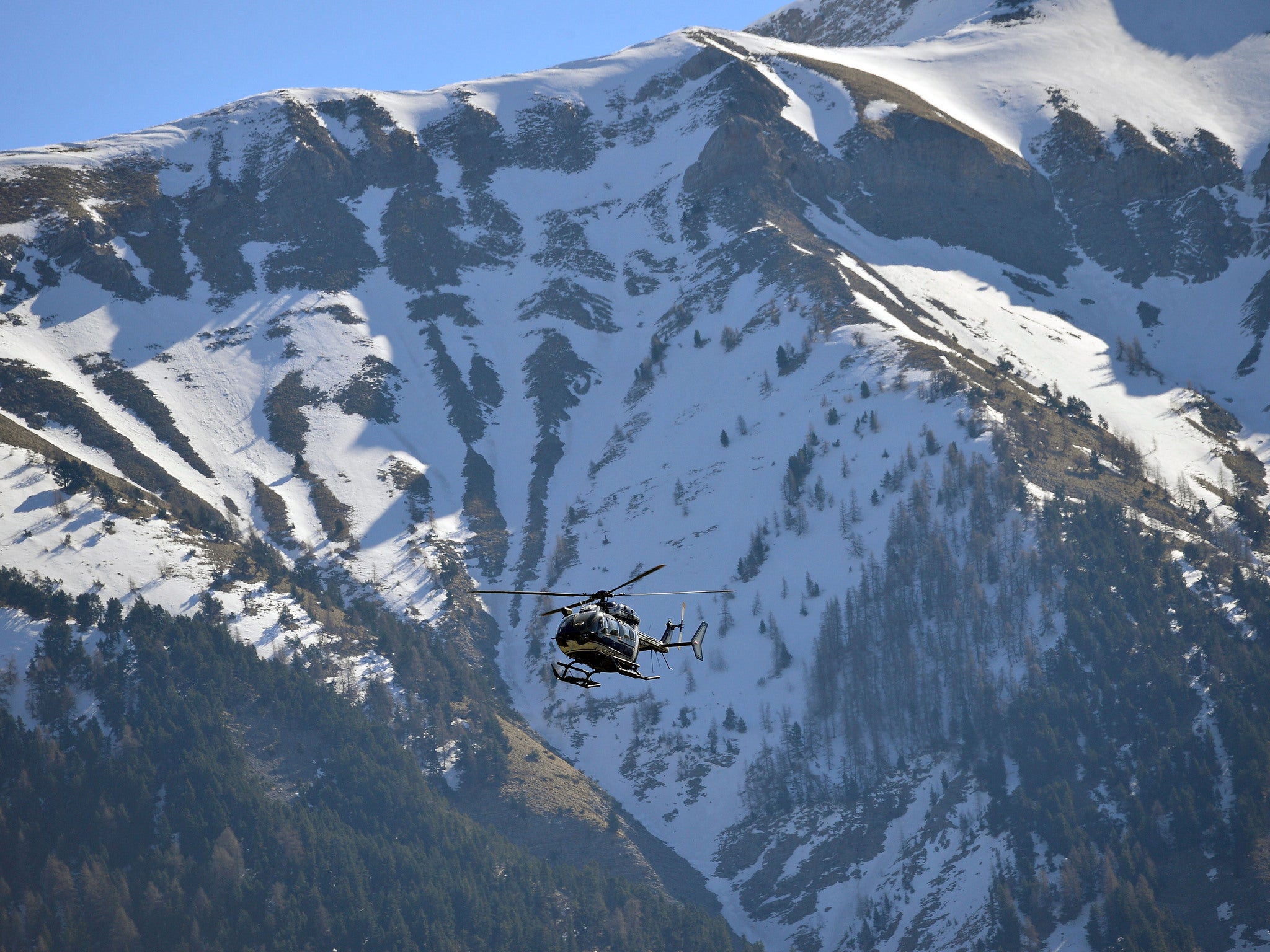 A rescue helicopter searches the crash site in Alpes-de-Haute-Provence, southern France
