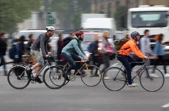 Cyclists cross a road junction near Vauxhall Bridge