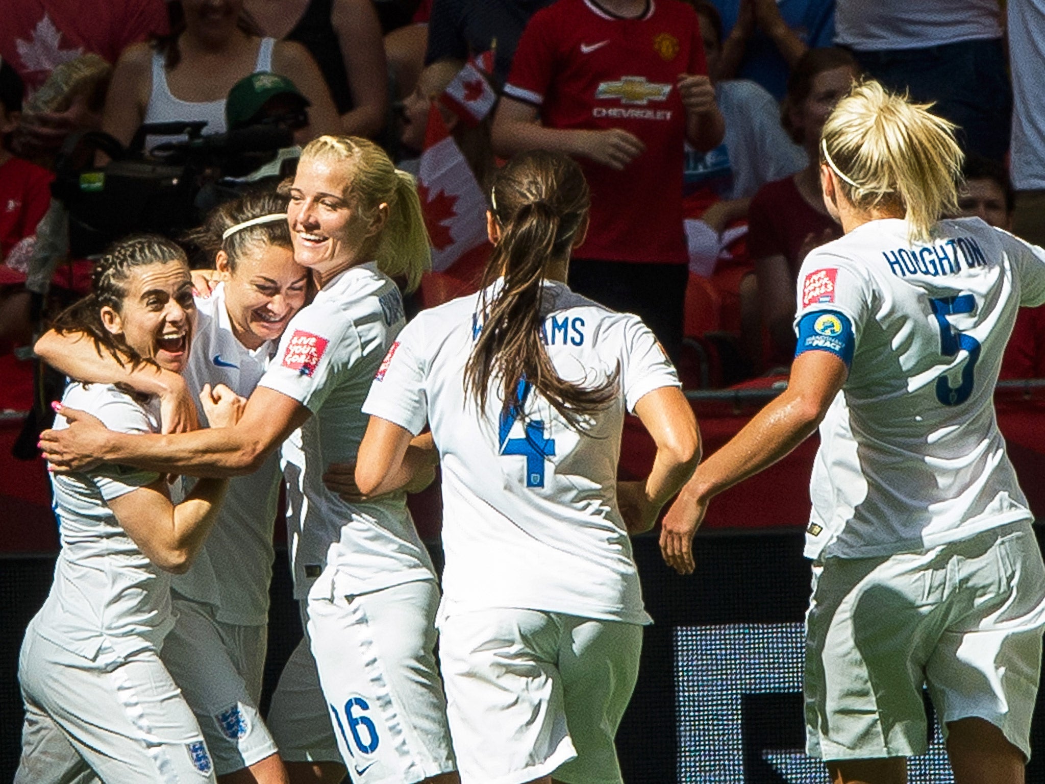 Jodie Taylor is congratulated by her England teammates after scoring against Canada