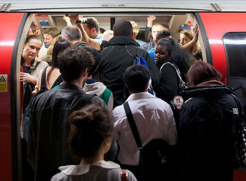 Passengers crowd on to a crammed Central line train, a common sight on the underground