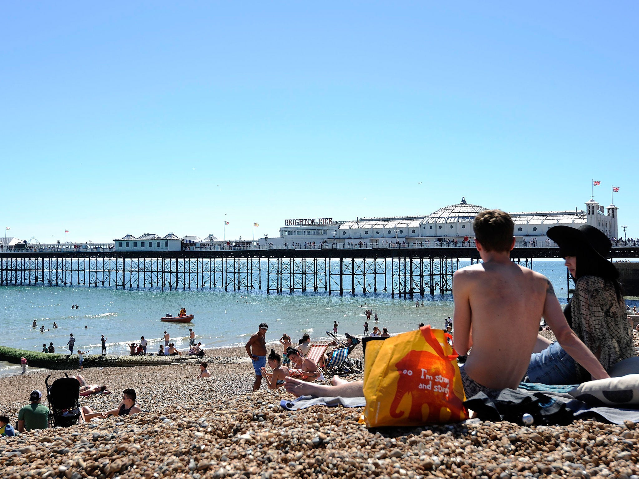 Sunbathers enjoy the hot weather on the beach in Brighton