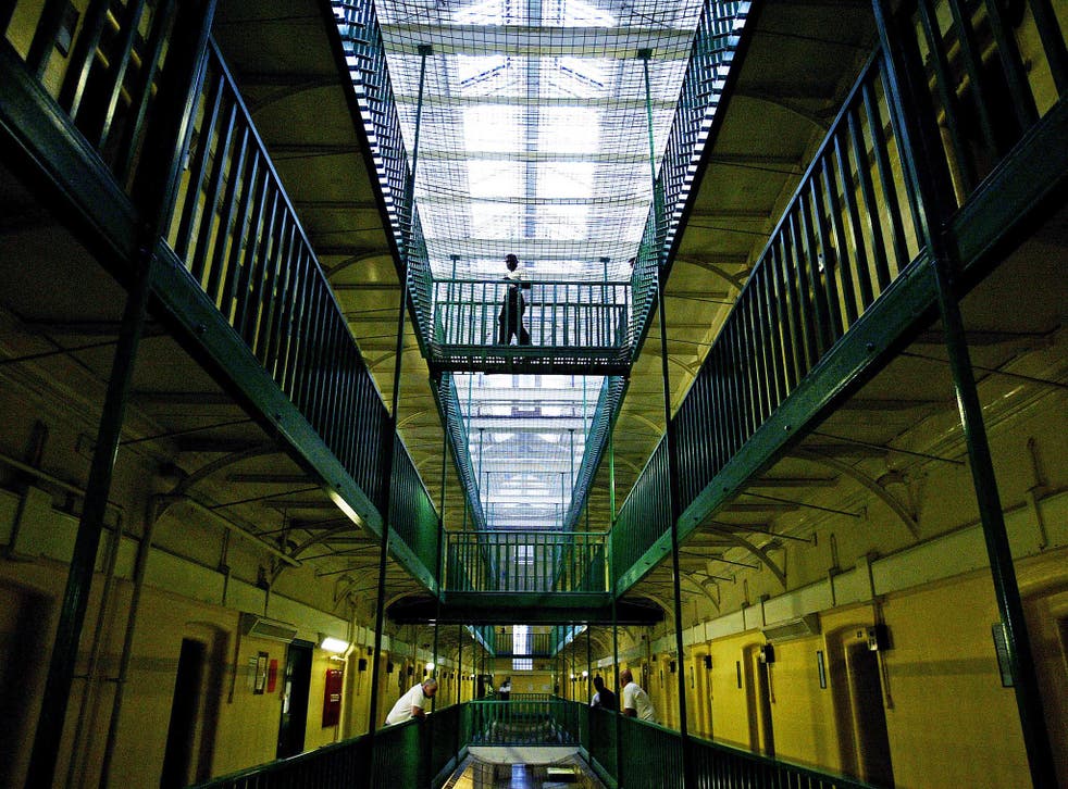 Prisoners at HMP Pentonville walk through an atrium