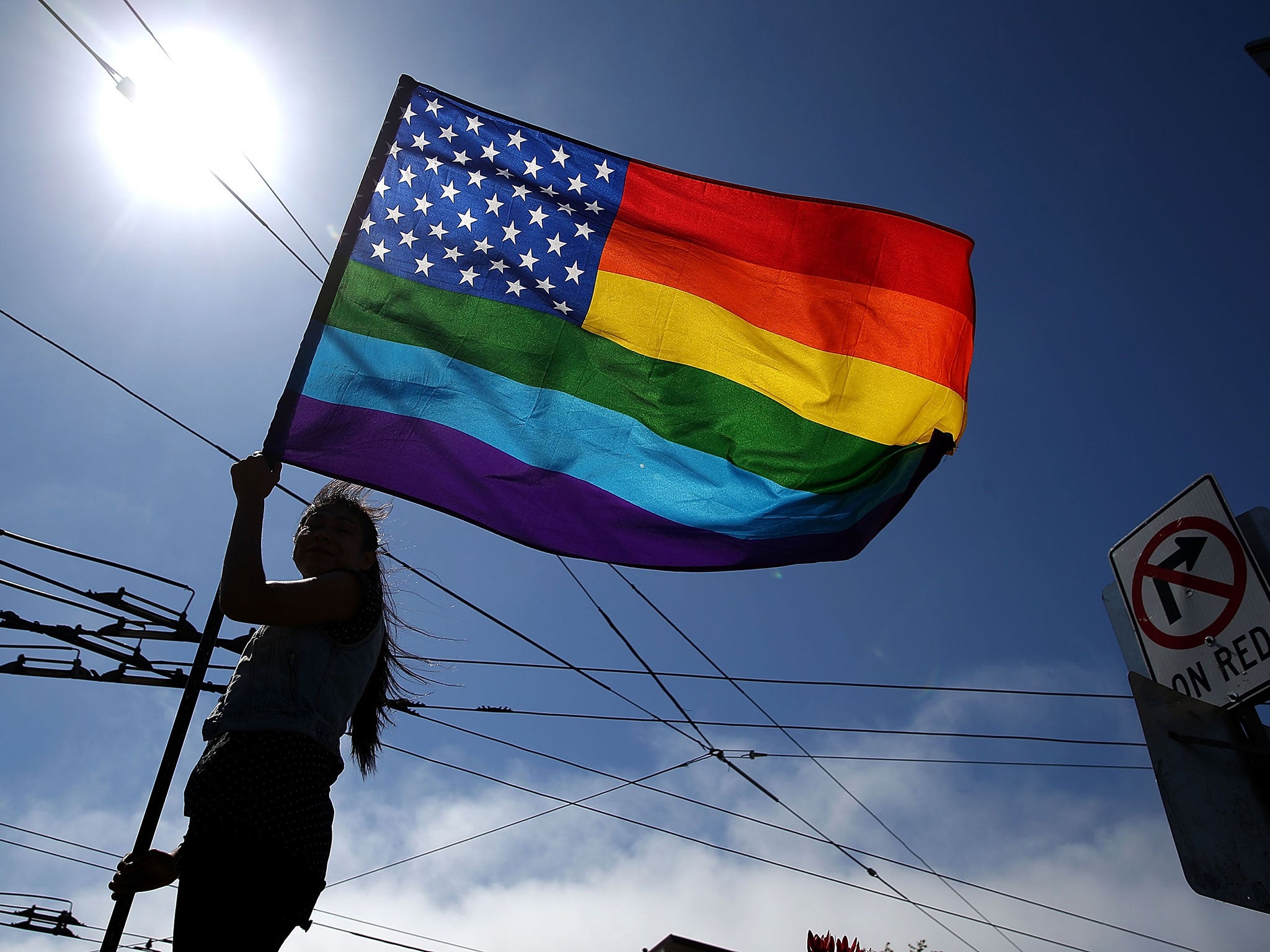 A same-sex marriage supporter waves a pride flag while celebrating the U.S Supreme Court ruling regarding same-sex marriage on June 26, 2015 in San Francisco, California