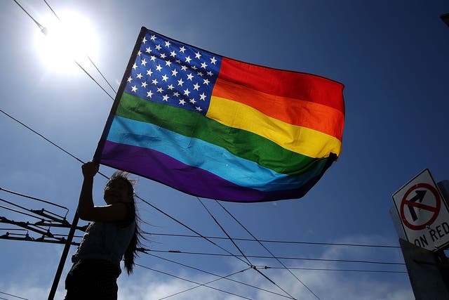 A same-sex marriage supporter waves a pride flag while celebrating the U.S Supreme Court ruling regarding same-sex marriage on June 26, 2015 in San Francisco, California