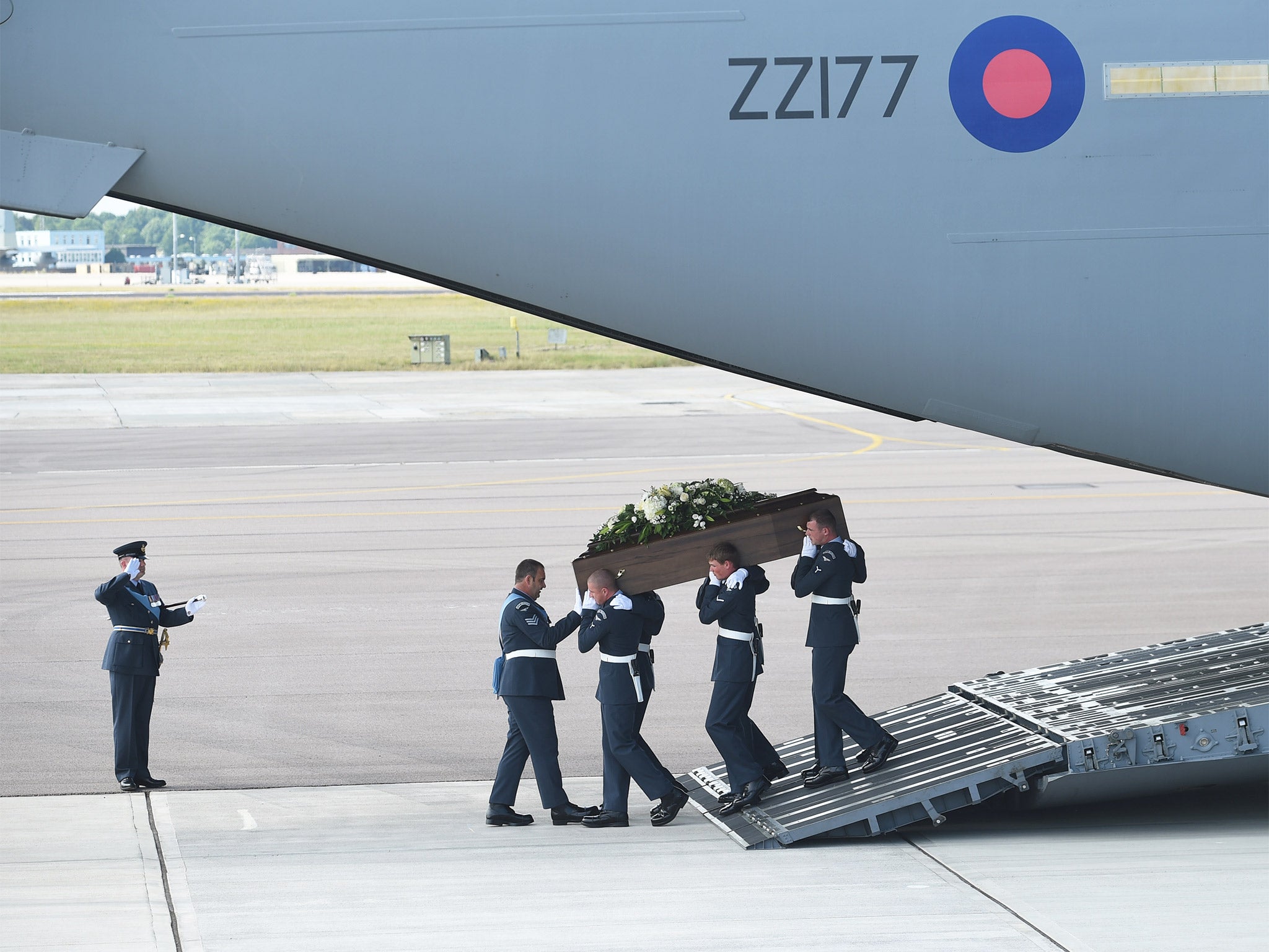 The coffin of Adrian Evans, one of the 27 British nationals killed in the Tunisia terror attack, is carried off a plane at RAF Brize Norton near Oxford on Wednesday