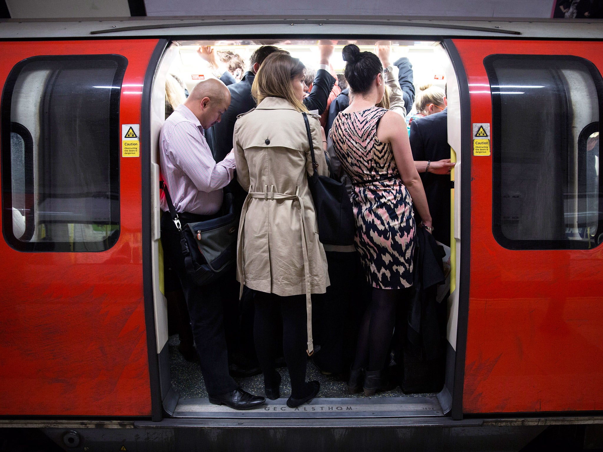 Underground passengers squeeze onto a train (Getty)