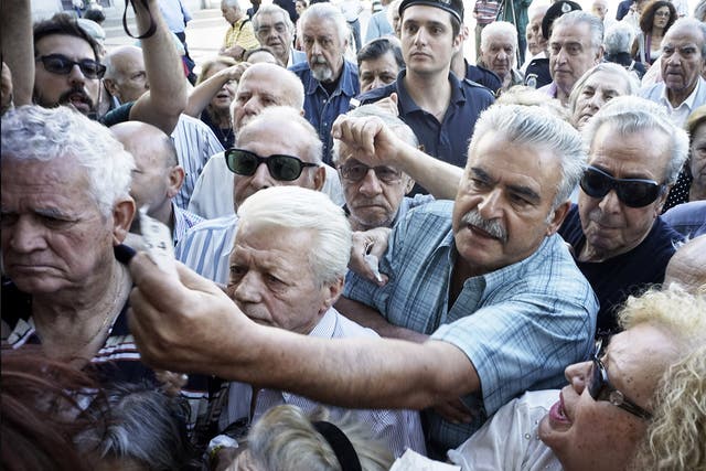 Pensioners line up outside a National Bank branch in Athens