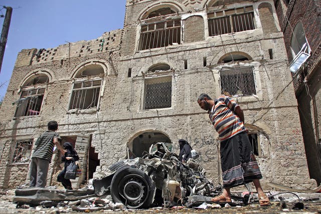 Yemeni civilians examine the wreck of a car-bomb in Sanaa earlier this week 