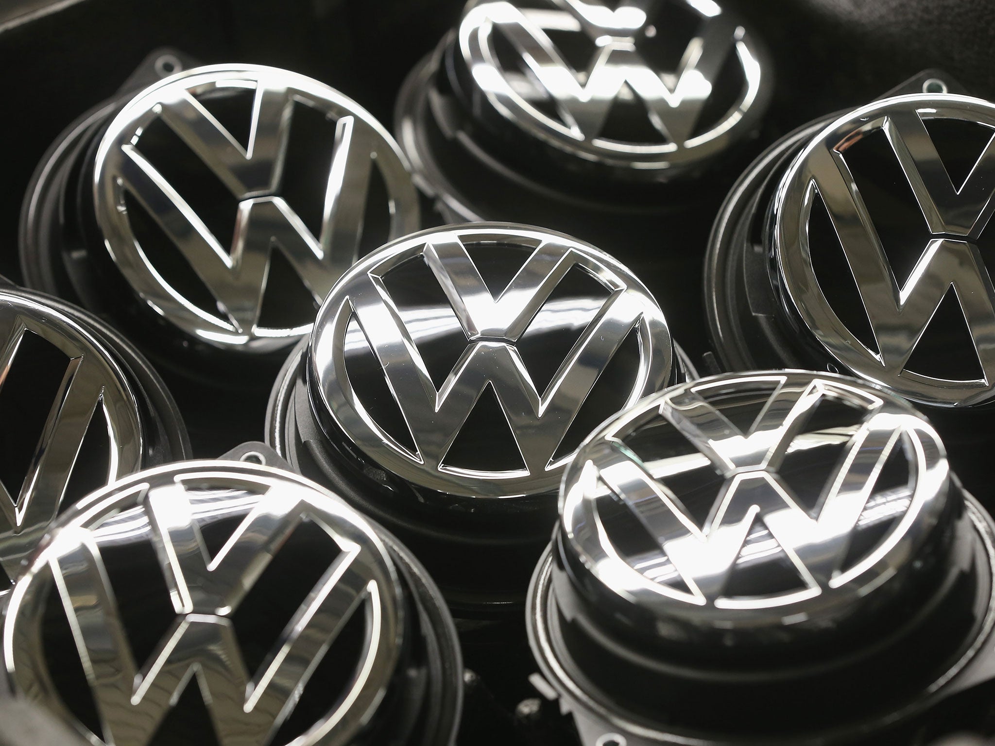 Volkswagen trunk ornaments bearing the VW logo lie next to the Golf VII assemly line at the Volkswagen factory on February 25, 2013 in Wolfsburg, Germany.